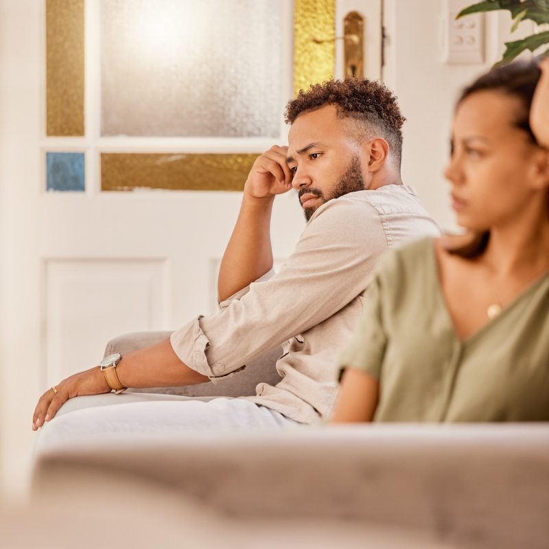 Stress, anxiety and divorce couple on living room sofa in house, home and marriage counseling after