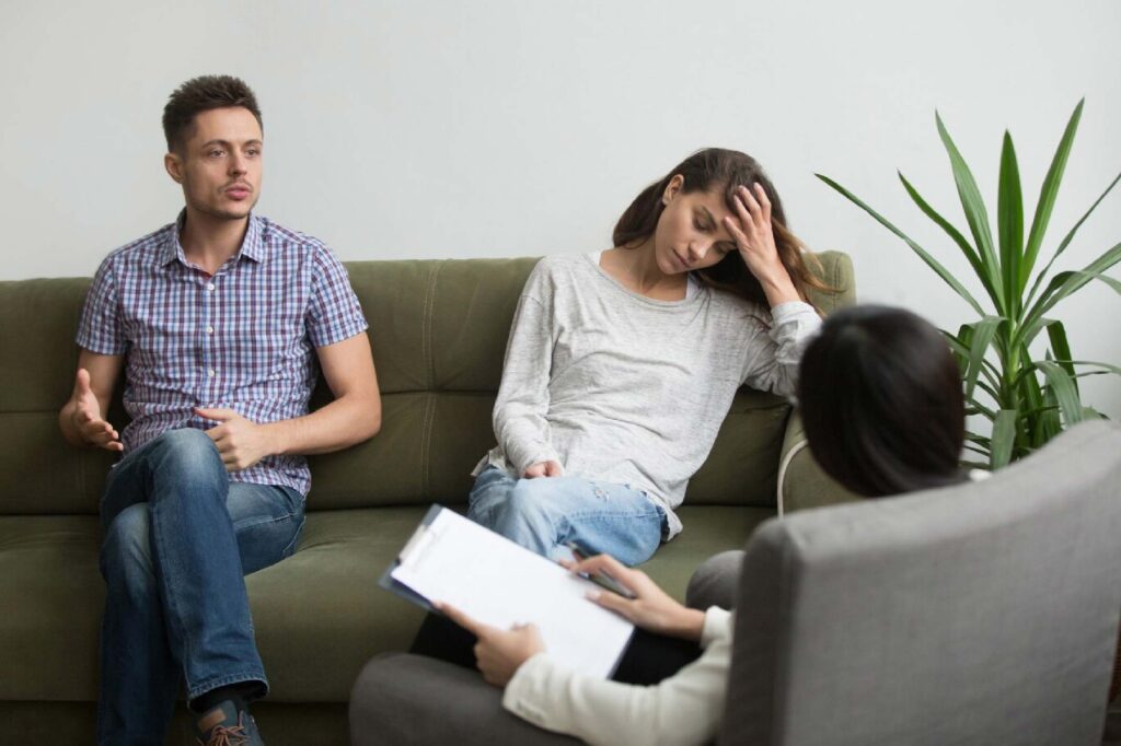 woman cheated by her husband taking counseling session with their therapist